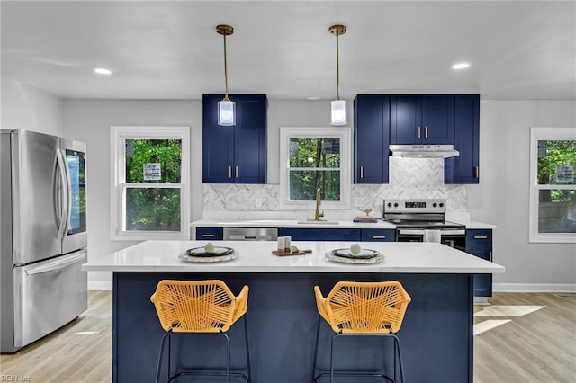 2 Clarendon Ct, Williamsburg, VA 23188 - kitchen featuring appliances with stainless steel finishes, blue cabinetry, a breakfast bar area, light countertops, and recessed lighting