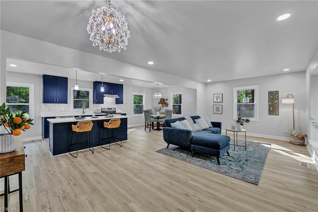 2 Clarendon Ct, Williamsburg, VA 23188 - living room with plenty of natural light, light wood finished floors, recessed lighting, and a chandelier