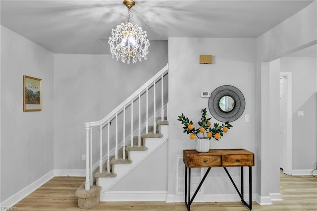 2 Clarendon Ct, Williamsburg, VA 23188 - stairway with wood finished floors and a chandelier