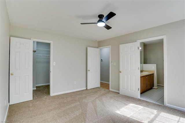816 Mccrae Dr, Newport News, VA 23608 - unfurnished bedroom with light colored carpet, a spacious closet, ensuite bathroom, a closet, and a ceiling fan