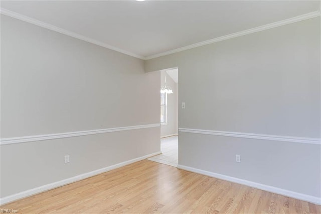 816 Mccrae Dr, Newport News, VA 23608 - spare room featuring a chandelier, wood finished floors, and ornamental molding