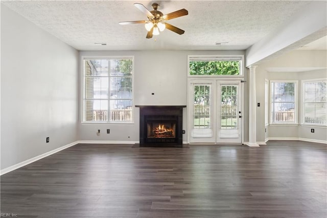 100 Peacepipe Pl, Williamsburg, VA 23185 - unfurnished living room with a textured ceiling, a fireplace with flush hearth, dark wood-style floors, ceiling fan, and ornate columns