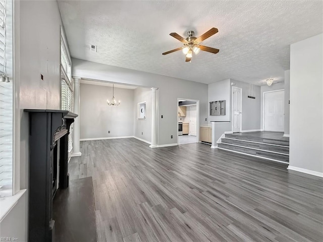 100 Peacepipe Pl, Williamsburg, VA 23185 - unfurnished living room featuring a chandelier, a ceiling fan, wood finished floors, a textured ceiling, and a fireplace