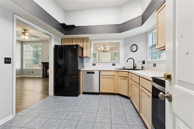 100 Peacepipe Pl, Williamsburg, VA 23185 - kitchen featuring freestanding refrigerator, light brown cabinetry, dishwasher, range, and a chandelier
