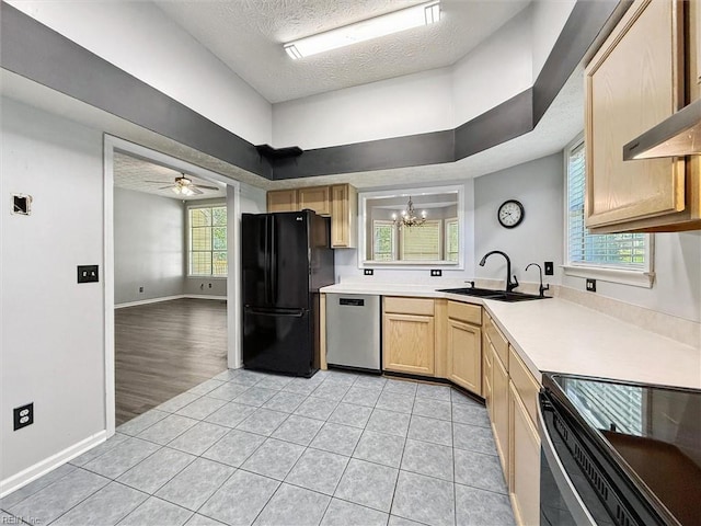 100 Peacepipe Pl, Williamsburg, VA 23185 - kitchen featuring freestanding refrigerator, stainless steel dishwasher, light brown cabinetry, a chandelier, and a textured ceiling