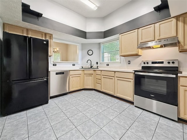 100 Peacepipe Pl, Williamsburg, VA 23185 - kitchen with appliances with stainless steel finishes, light brown cabinetry, under cabinet range hood, light countertops, and a textured ceiling