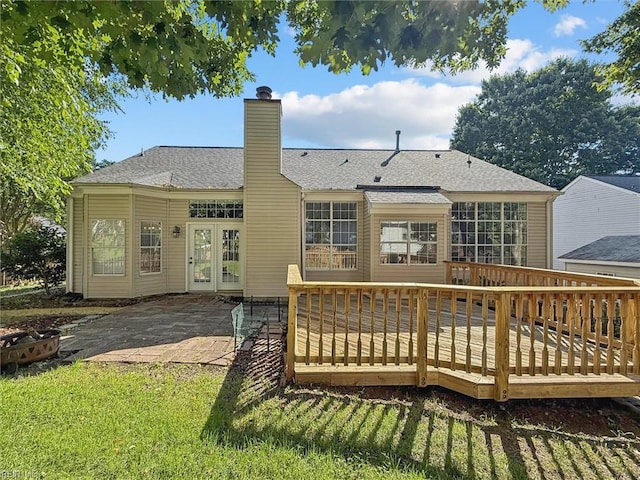 100 Peacepipe Pl, Williamsburg, VA 23185 - back of property featuring a deck, a chimney, a patio area, and a shingled roof