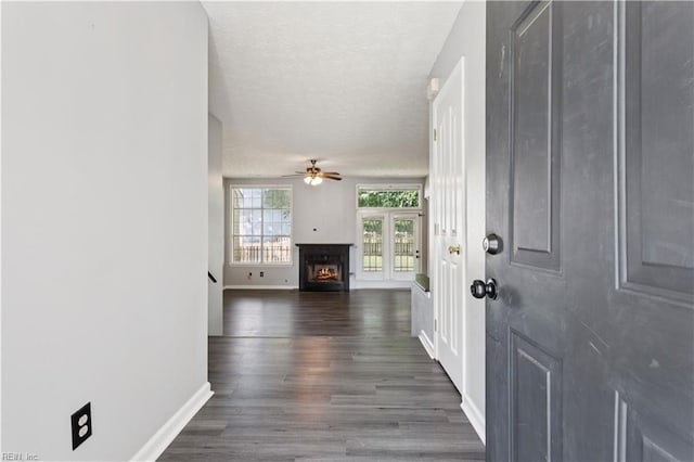 100 Peacepipe Pl, Williamsburg, VA 23185 - foyer entrance with a ceiling fan, a lit fireplace, dark wood-type flooring, and a textured ceiling