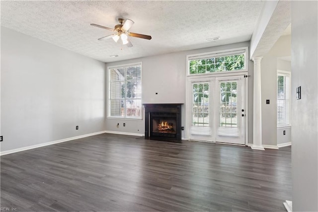 100 Peacepipe Pl, Williamsburg, VA 23185 - unfurnished living room featuring a textured ceiling, ceiling fan, a fireplace with flush hearth, dark wood-type flooring, and healthy amount of natural light