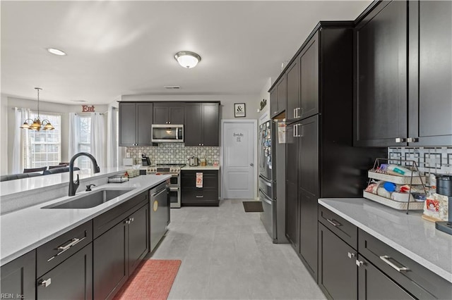 1949 Lemonwood Rd, Chesapeake, VA 23323 - kitchen with stainless steel appliances, tasteful backsplash, light countertops, a chandelier, and decorative light fixtures