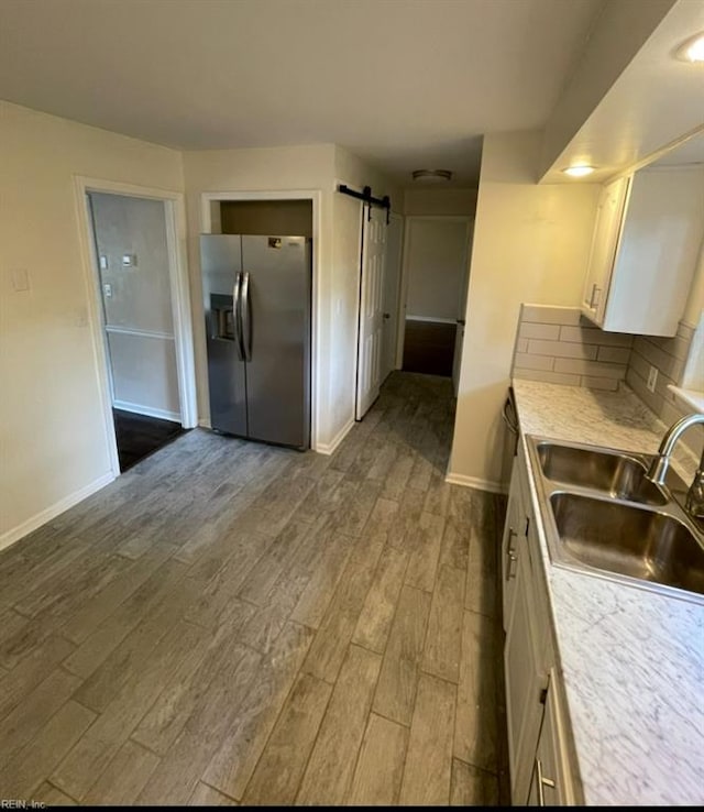 2932 Sunrise Ave, Chesapeake, VA 23324 - kitchen featuring stainless steel fridge, dark wood-style floors, white cabinets, and light countertops