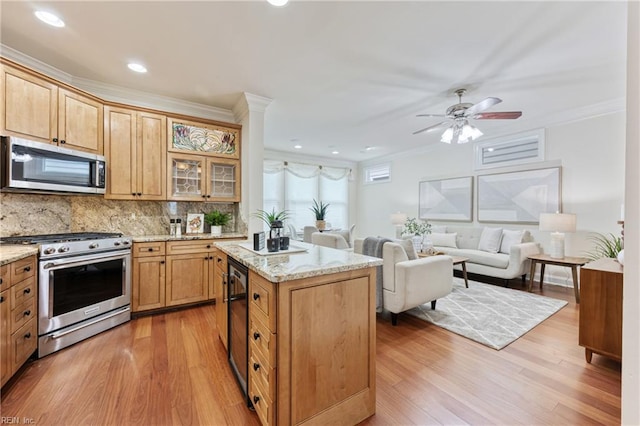 623 London St, Portsmouth, VA 23704 - kitchen with appliances with stainless steel finishes, light wood finished floors, ornamental molding, decorative backsplash, and light stone countertops
