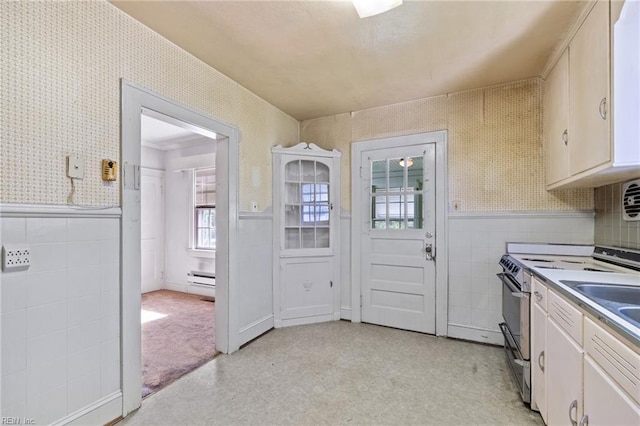 1132 Proctor St, Suffolk, VA 23434 - kitchen featuring stainless steel range with electric stovetop, wallpapered walls, wainscoting, tile walls, and a baseboard heating unit
