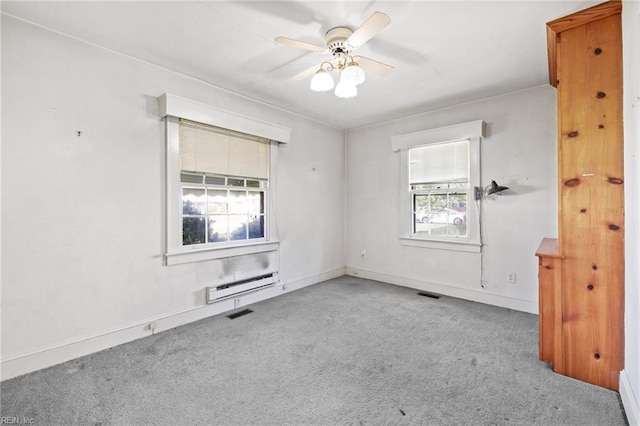 1132 Proctor St, Suffolk, VA 23434 - spare room featuring carpet flooring, plenty of natural light, a baseboard radiator, and a ceiling fan