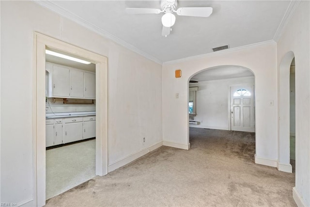 1132 Proctor St, Suffolk, VA 23434 - spare room with arched walkways, light carpet, crown molding, and ceiling fan