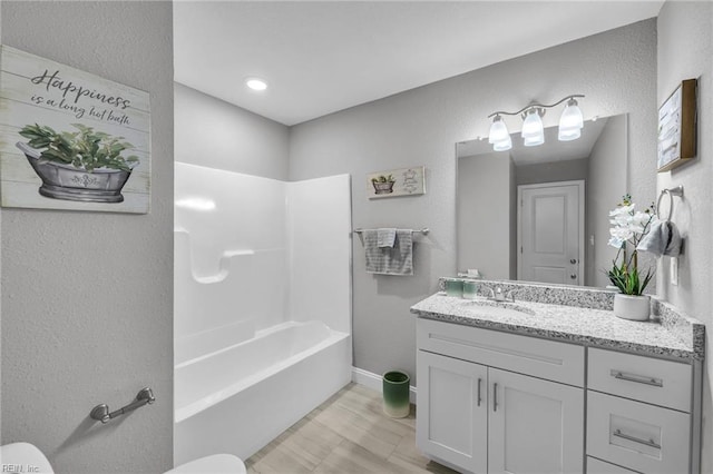 464 Factory St, Suffolk, VA 23434 - bathroom featuring a textured wall, vanity, and bathing tub / shower combination