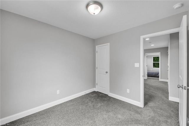 464 Factory St, Suffolk, VA 23434 - unfurnished bedroom with dark colored carpet and baseboards