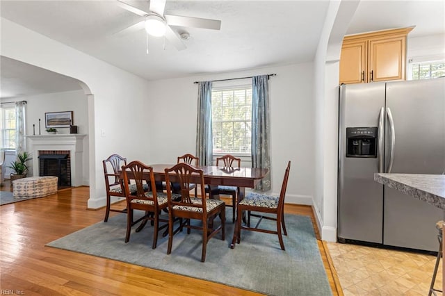 414 Russell St, Portsmouth, VA 23707 - dining room featuring healthy amount of natural light, a ceiling fan, arched walkways, and light wood finished floors