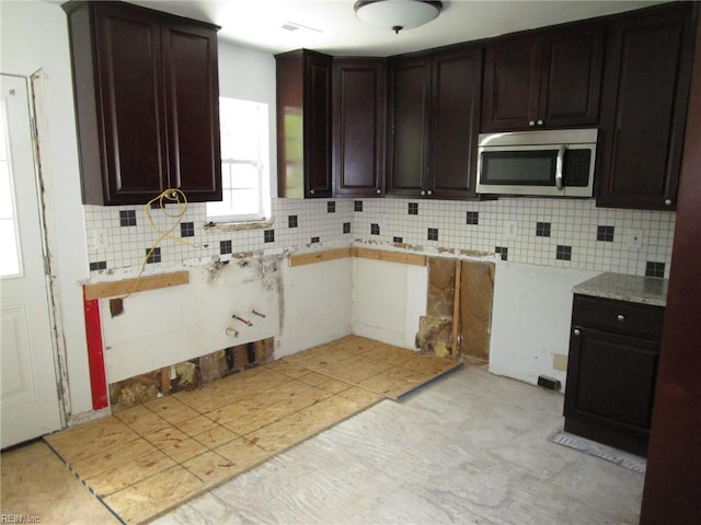 1314 18th St, Chesapeake, VA 23324 - kitchen with stainless steel microwave, tasteful backsplash, dark brown cabinetry, and light countertops