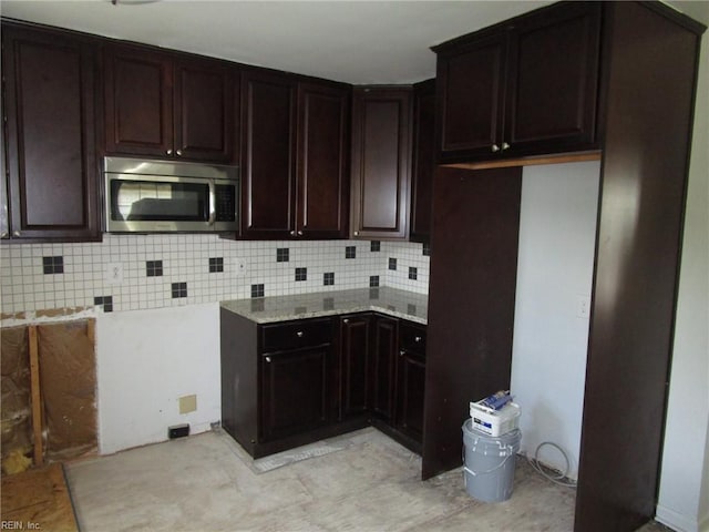 1314 18th St, Chesapeake, VA 23324 - kitchen with stainless steel microwave, tasteful backsplash, and dark brown cabinets