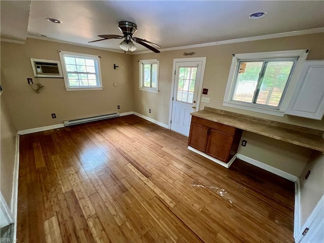 5410 Gum Fork Rd, Gloucester, VA 23061 - unfurnished living room featuring baseboard heating, crown molding, a wall mounted air conditioner, hardwood / wood-style flooring, and ceiling fan