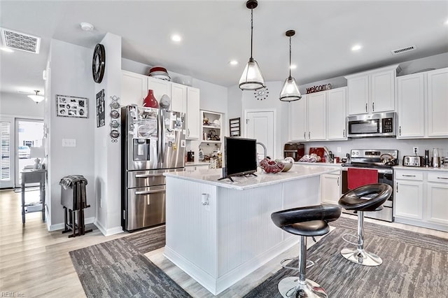 145 Blessing Cir, Suffolk, VA 23434 - kitchen featuring stainless steel appliances, light countertops, light wood-style flooring, white cabinetry, and recessed lighting