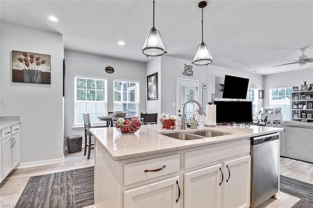 145 Blessing Cir, Suffolk, VA 23434 - kitchen featuring stainless steel dishwasher, open floor plan, light stone counters, white cabinets, and a center island with sink