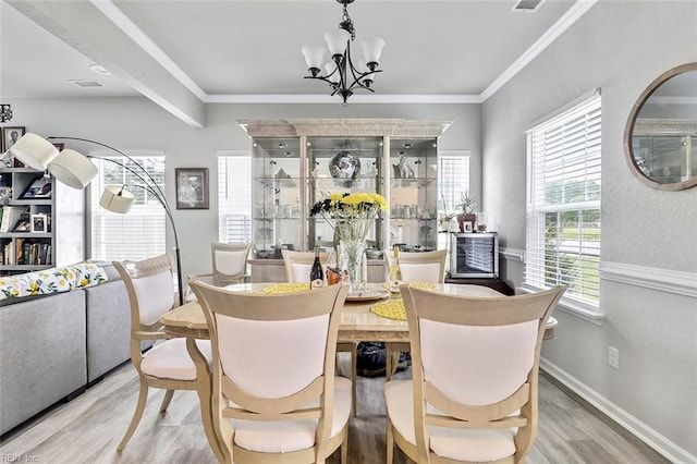 145 Blessing Cir, Suffolk, VA 23434 - dining area featuring wood finished floors, a chandelier, and crown molding