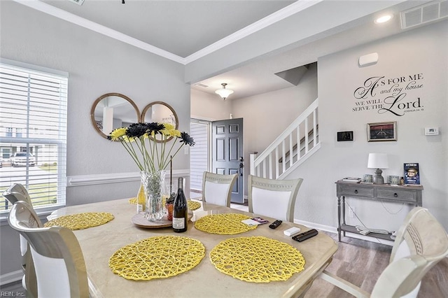 145 Blessing Cir, Suffolk, VA 23434 - dining space featuring wood finished floors, crown molding, and stairs