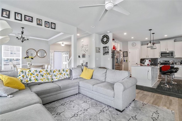 145 Blessing Cir, Suffolk, VA 23434 - living area featuring light wood finished floors, ceiling fan, a chandelier, and recessed lighting