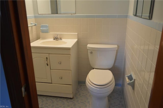 301 Woodbridge Dr, Chesapeake, VA 23322 - bathroom featuring vanity, tile walls, a wainscoted wall, and tile patterned floors