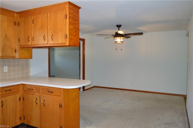 301 Woodbridge Dr, Chesapeake, VA 23322 - kitchen featuring ceiling fan, light countertops, backsplash, a peninsula, and carpet floors