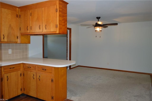 301 Woodbridge Dr, Chesapeake, VA 23322 - kitchen with ceiling fan, decorative backsplash, light countertops, a peninsula, and dark carpet