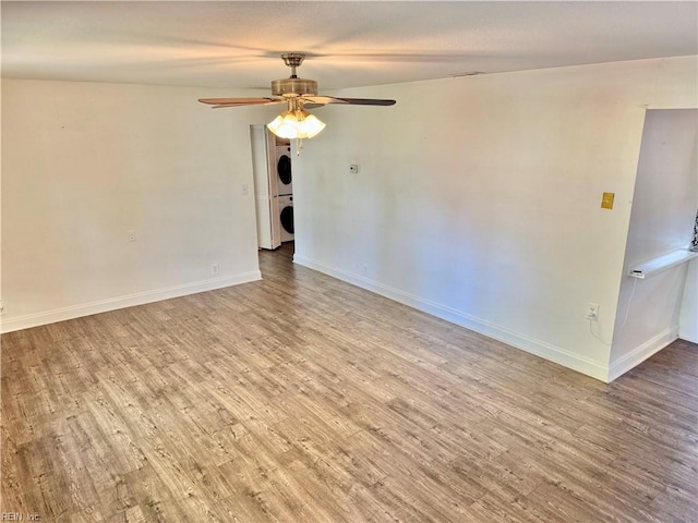 613 N Shore Rd, Norfolk, VA 23505 - empty room featuring stacked washer / dryer, wood finished floors, and ceiling fan