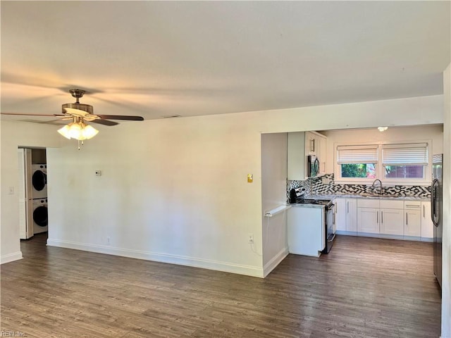 613 N Shore Rd, Norfolk, VA 23505 - kitchen featuring range, stacked washing machine and dryer, stainless steel microwave, dark wood-style floors, and a ceiling fan