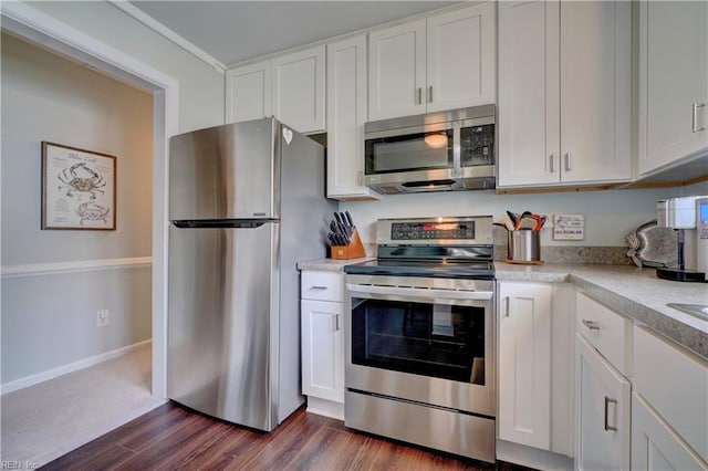 215 Lisbon Dr, Newport News, VA 23601 - kitchen with stainless steel appliances, light countertops, dark wood-style floors, and white cabinets