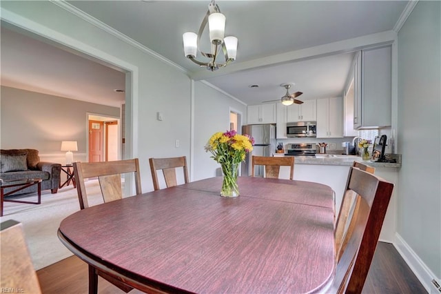 215 Lisbon Dr, Newport News, VA 23601 - dining area with wood finished floors, a chandelier, crown molding, and ceiling fan