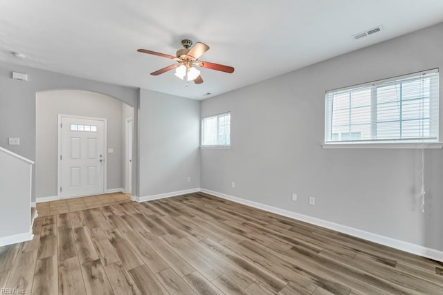923 Hill St, Chesapeake, VA 23324 - empty room featuring arched walkways, a ceiling fan, and wood finished floors