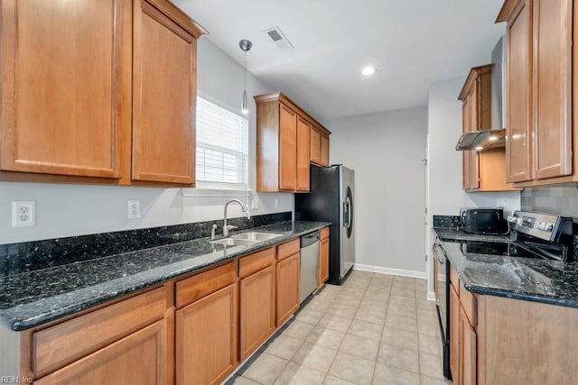 923 Hill St, Chesapeake, VA 23324 - kitchen featuring appliances with stainless steel finishes, dark stone countertops, brown cabinets, light tile patterned floors, and decorative light fixtures