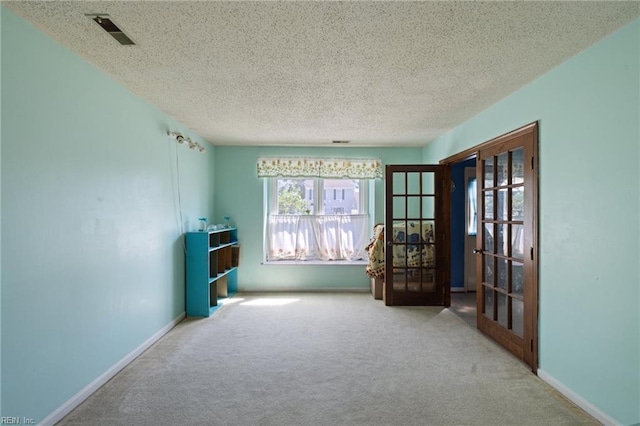 3909 Wilmington Rd, Virginia Beach, VA 23453 - unfurnished room with french doors, carpet flooring, and a textured ceiling