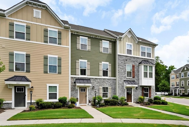 1803 Yardarm Way, Chesapeake, VA 23323 - townhome / multi-family property with stone siding, board and batten siding, and a front lawn