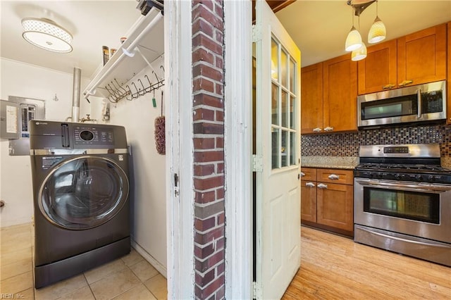 556 Summers Dr, Norfolk, VA 23509 - laundry area with washer / dryer and light tile patterned floors