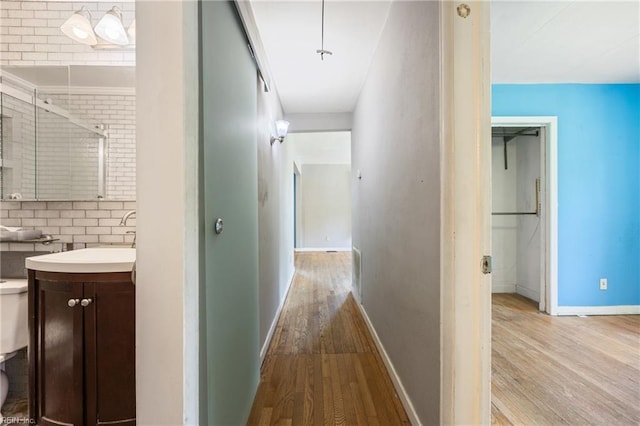 556 Summers Dr, Norfolk, VA 23509 - corridor with wood finished floors and a sink