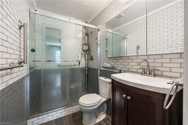 556 Summers Dr, Norfolk, VA 23509 - bathroom featuring tile walls, vanity, a shower stall, wood finished floors, and crown molding