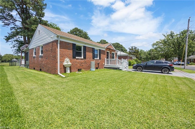556 Summers Dr, Norfolk, VA 23509 - view of front facade with brick siding, a front yard, and concrete driveway