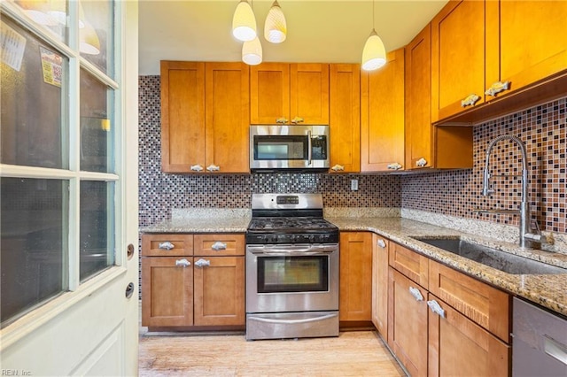 556 Summers Dr, Norfolk, VA 23509 - kitchen featuring appliances with stainless steel finishes, backsplash, brown cabinetry, and light stone counters