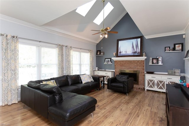 108 Sunrise Bluff Ct, Smithfield, VA 23430 - living area with wood finished floors, a ceiling fan, a skylight, a brick fireplace, and crown molding