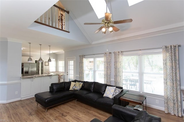 108 Sunrise Bluff Ct, Smithfield, VA 23430 - living area with light wood finished floors, crown molding, high vaulted ceiling, a ceiling fan, and a skylight
