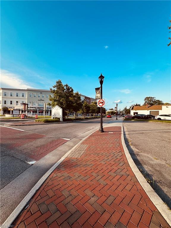 1204 Holly Ave, Chesapeake, VA 23324 - view of asphalt street featuring street lighting, curbs, sidewalks, and traffic signs