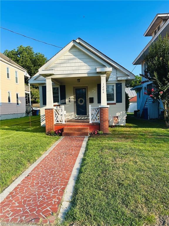 1204 Holly Ave, Chesapeake, VA 23324 - view of front of home with a front lawn and a porch